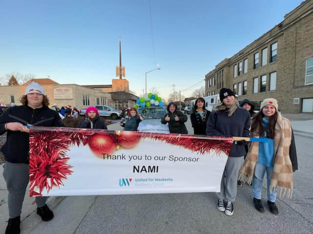 Volunteers holding NAMI parade banner